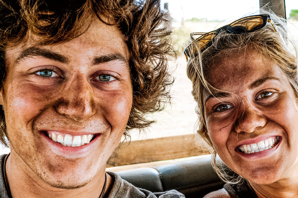 Selfie of best friends couple making adventure experience in Hawaii. Boyfriend and girlfriend smiling with dirty faces after a safari tour. Concept of amazing travelling with incredible holiday