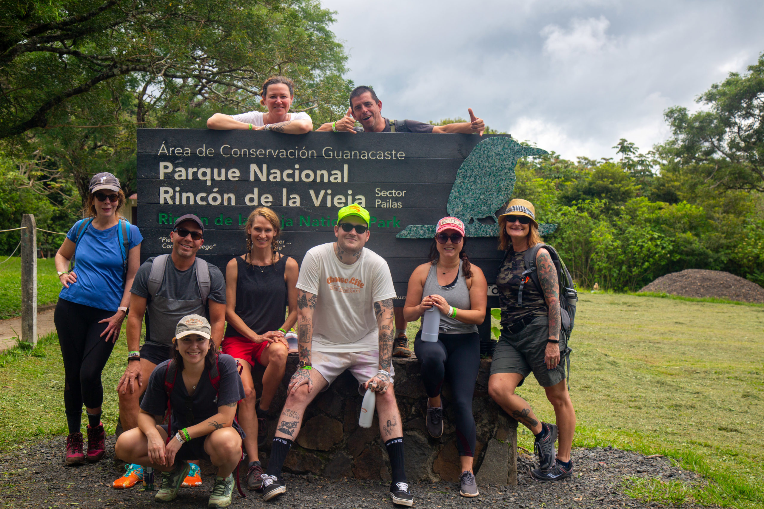 Sober travelers pose in front of the Rincon de la Vieia National Park sign.
