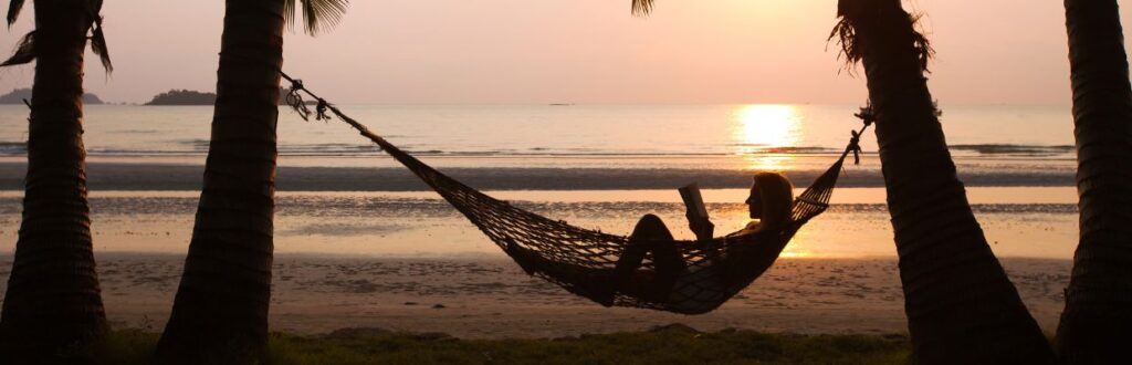 Woman laying on hammock in tropical area